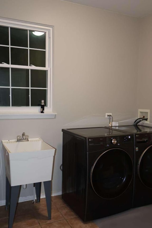 washroom with laundry area, baseboards, separate washer and dryer, and tile patterned floors