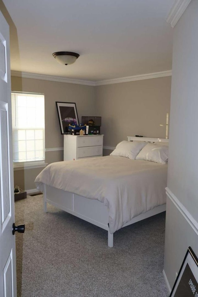 bedroom with carpet, baseboards, and crown molding