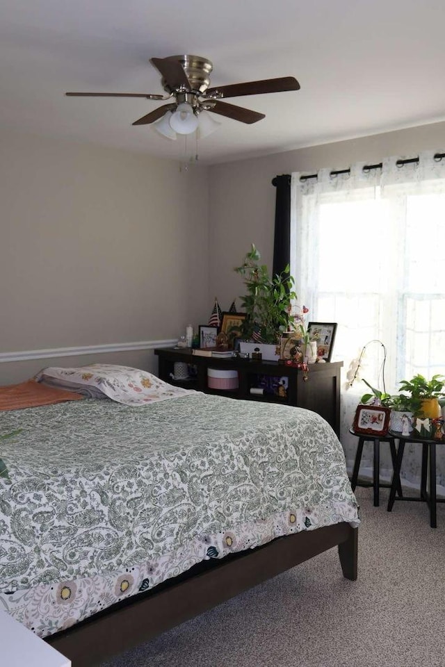 bedroom featuring carpet, a ceiling fan, and baseboards