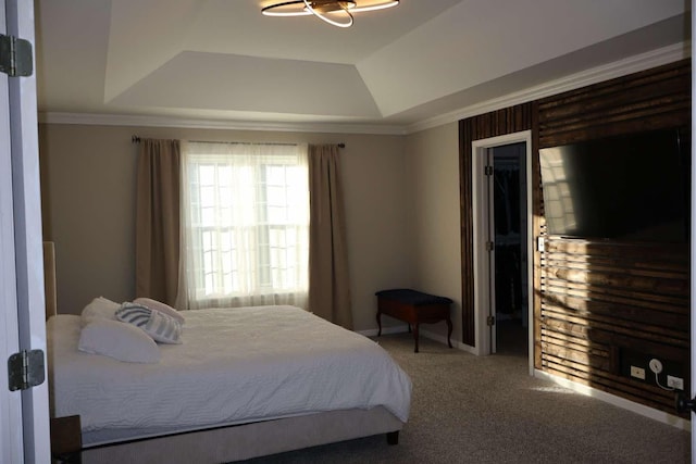 bedroom with carpet, a raised ceiling, and crown molding