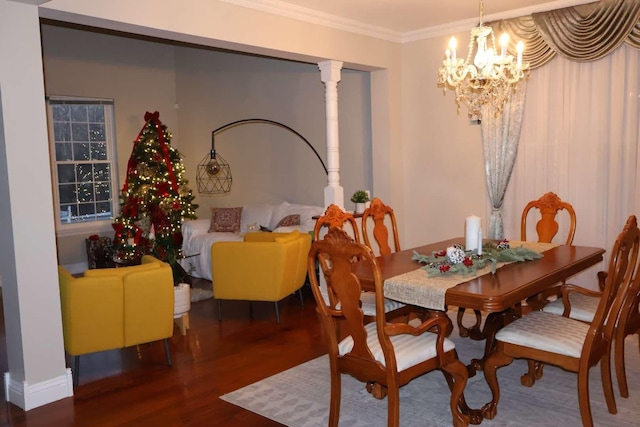 dining area with ornamental molding, a notable chandelier, and wood finished floors