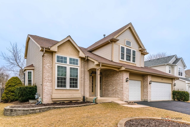 traditional home featuring a garage, a shingled roof, aphalt driveway, and brick siding