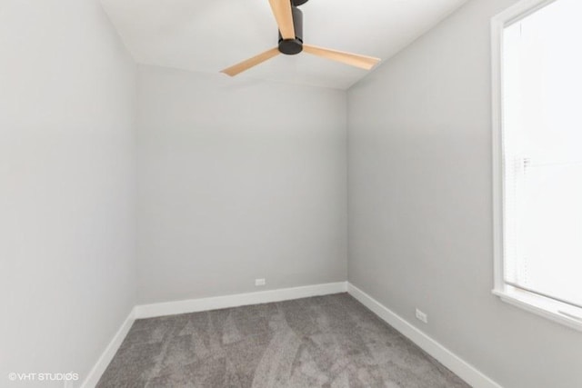 empty room featuring baseboards, ceiling fan, and light colored carpet