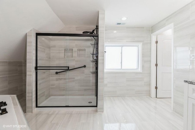 full bathroom with a stall shower, visible vents, and tile patterned floors