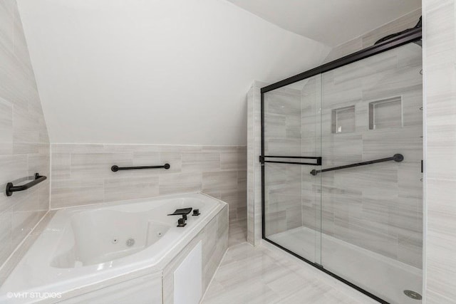 bathroom featuring a stall shower and a tub with jets