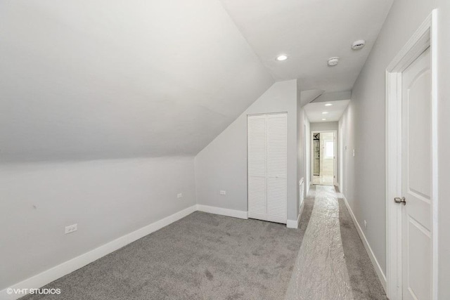 bonus room featuring recessed lighting, baseboards, vaulted ceiling, and light colored carpet