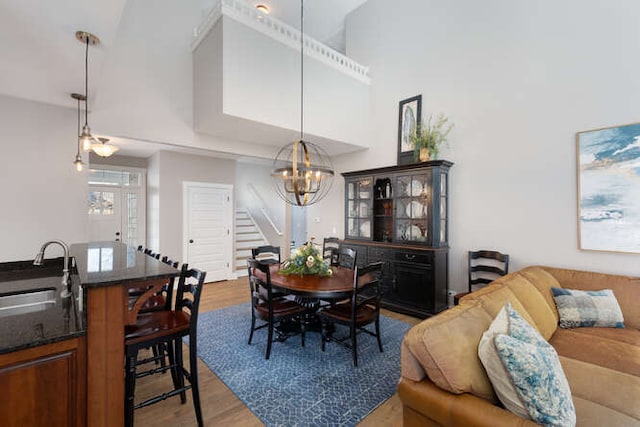 9 Cottage Grn, Ottawa, IL 61350 - dining room with a towering ceiling, wood finished floors, a chandelier, and stairs