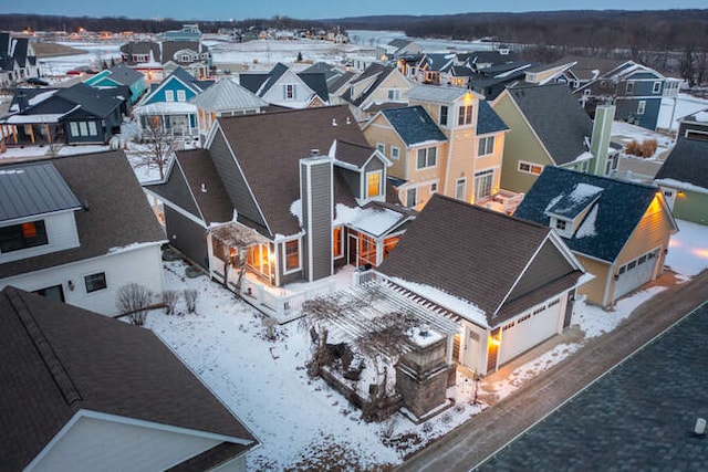 snowy aerial view with a residential view