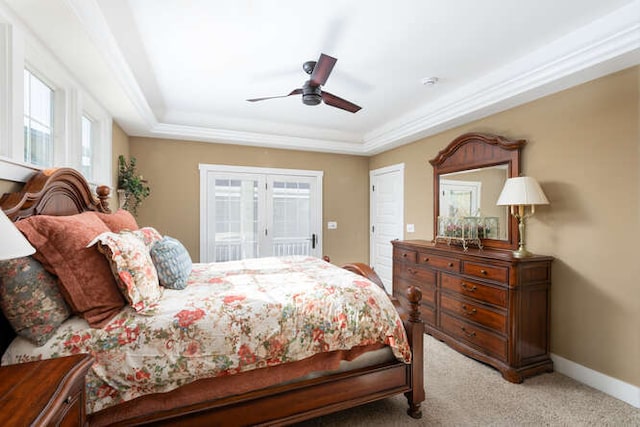 bedroom with a ceiling fan, light colored carpet, crown molding, and baseboards