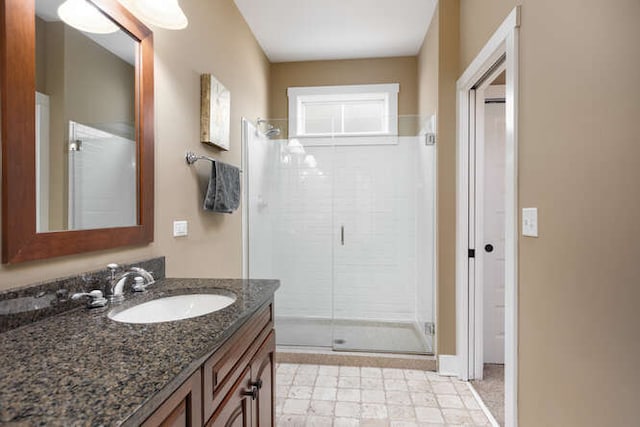 bathroom with a stall shower and vanity