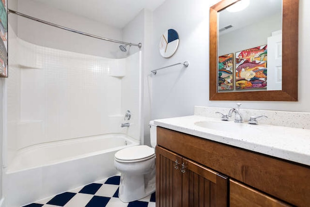 bathroom with tub / shower combination, vanity, toilet, and tile patterned floors