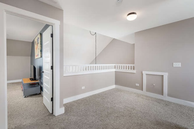 empty room with baseboards and light colored carpet