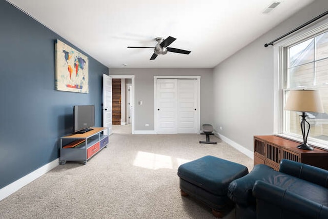 living area featuring visible vents, baseboards, and carpet flooring