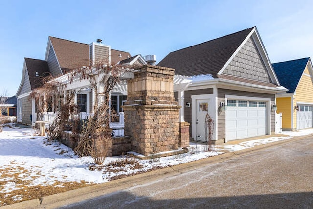 view of front of property with a chimney and an attached garage