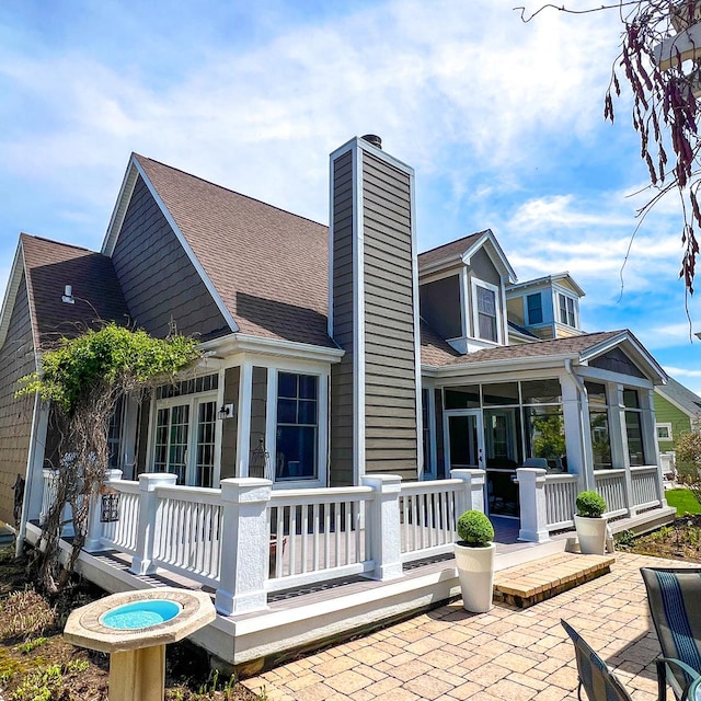 9 Cottage Grn, Ottawa, IL 61350 - back of house with a patio, a sunroom, a shingled roof, and a chimney