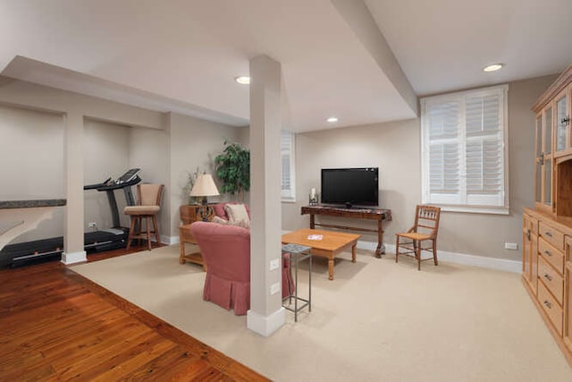 living room with recessed lighting, baseboards, and wood finished floors