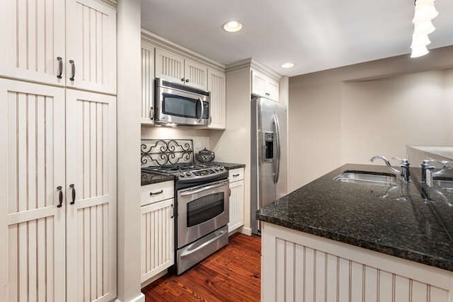 9 Cottage Grn, Ottawa, IL 61350 - kitchen with recessed lighting, dark wood-style floors, dark stone countertops, a sink, and appliances with stainless steel finishes