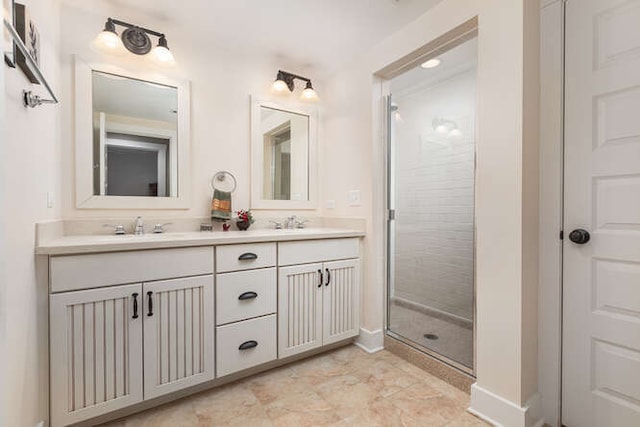 bathroom featuring a sink, double vanity, and a shower stall