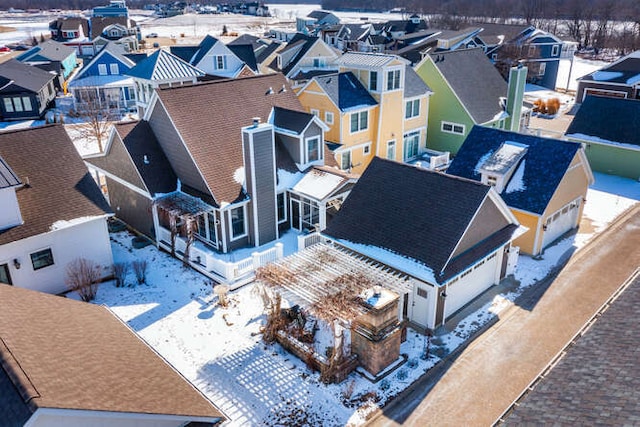 snowy aerial view with a residential view