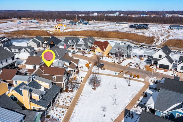 snowy aerial view featuring a residential view