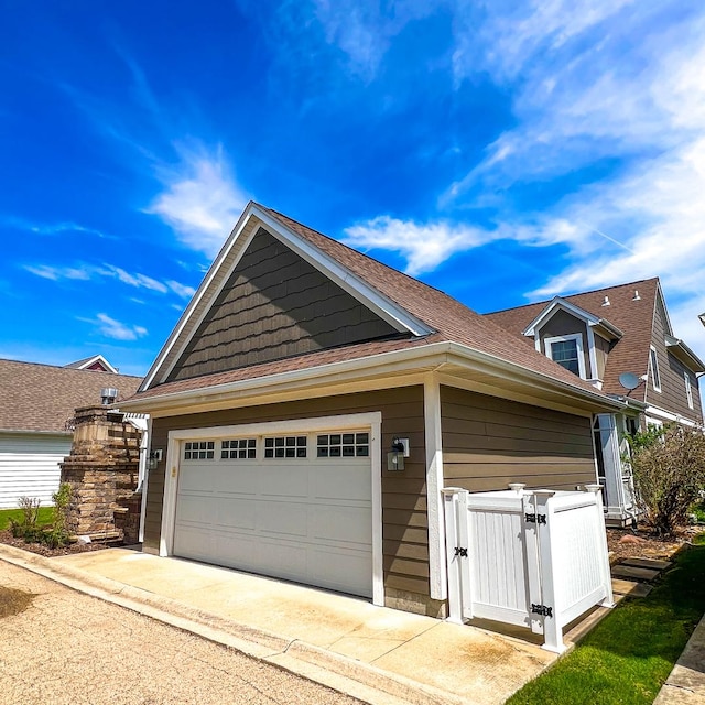 9 Cottage Grn, Ottawa, IL 61350 - view of front facade with a gate, driveway, and a garage
