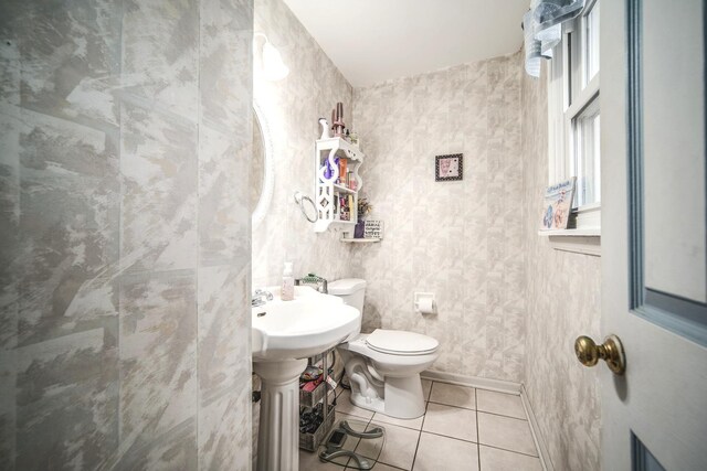 bathroom featuring toilet and tile patterned flooring