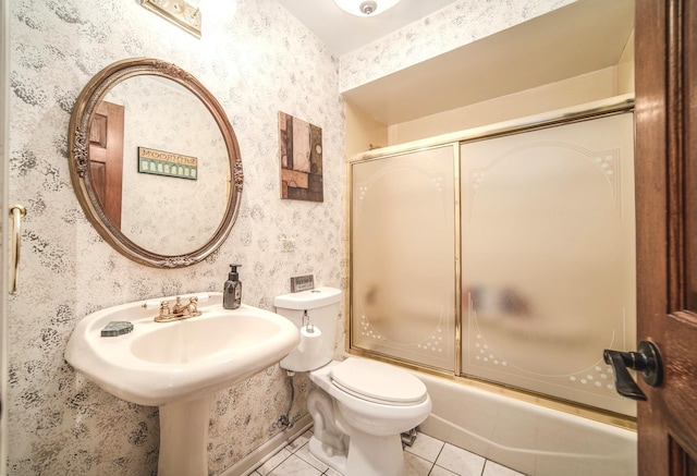 bathroom featuring toilet, wallpapered walls, tile patterned flooring, and enclosed tub / shower combo