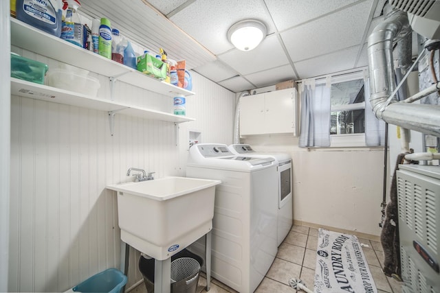 washroom with washer and dryer, laundry area, a sink, and light tile patterned floors