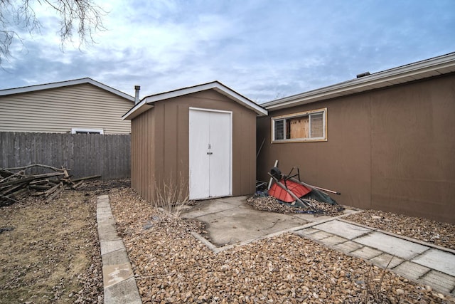 view of shed with fence