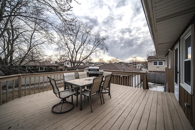 wooden deck featuring outdoor dining space and grilling area