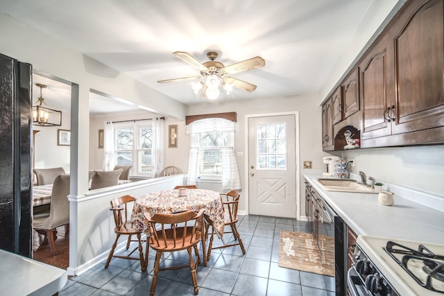 dining area featuring plenty of natural light, baseboards, ceiling fan, and tile patterned flooring