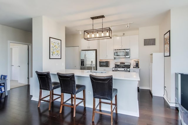 kitchen featuring stainless steel appliances, visible vents, white cabinets, light countertops, and pendant lighting