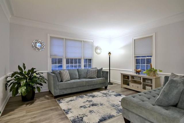 living room featuring baseboards, ornamental molding, and wood finished floors