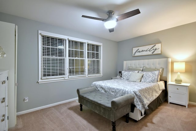 bedroom featuring light carpet, ceiling fan, and baseboards