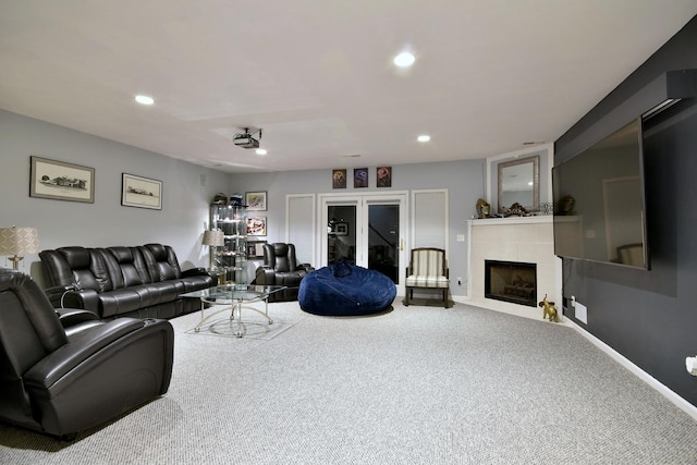 carpeted living room with baseboards, a tiled fireplace, and recessed lighting