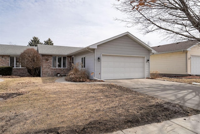 ranch-style home featuring a garage, concrete driveway, and brick siding