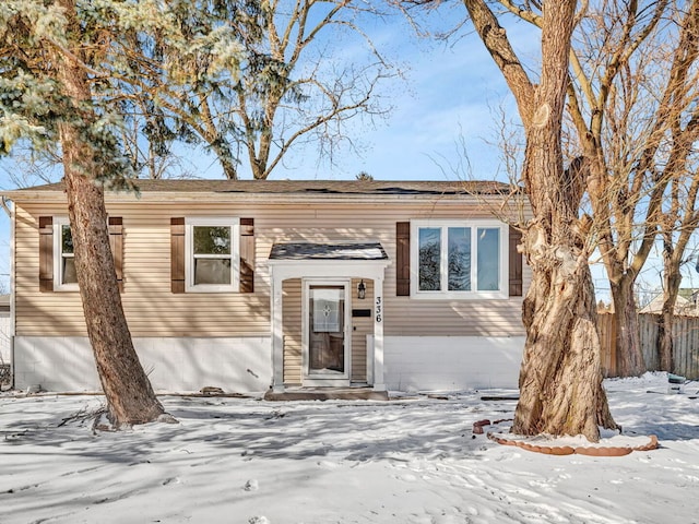 split foyer home featuring fence