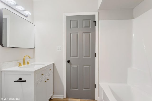 bathroom with a bath and vanity