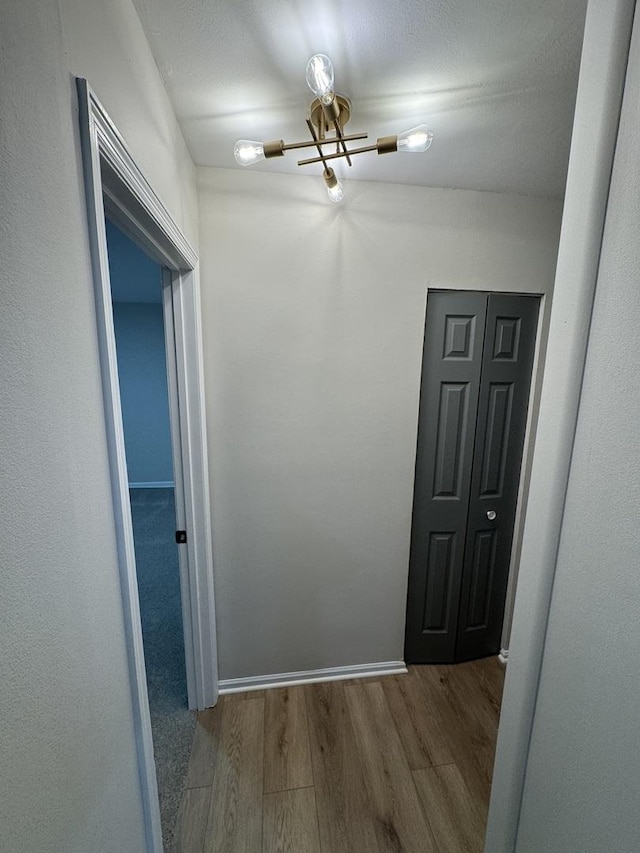 hallway with light wood-style flooring and baseboards