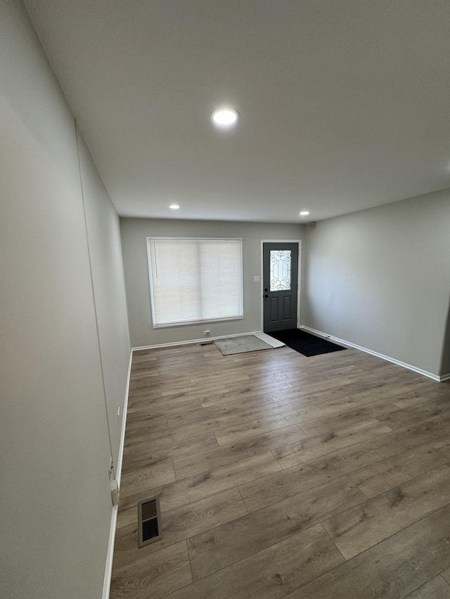 entryway featuring recessed lighting, visible vents, baseboards, and wood finished floors