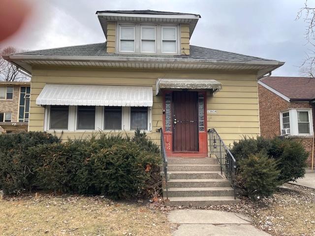 bungalow-style house with entry steps and roof with shingles