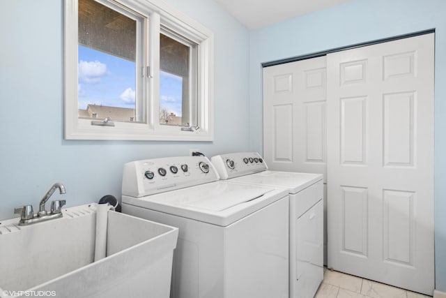 washroom with laundry area, a sink, washer and clothes dryer, and marble finish floor