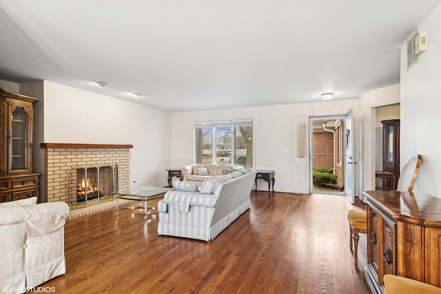 living area featuring a fireplace and wood finished floors