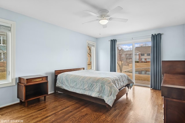 bedroom featuring access to exterior, ceiling fan, baseboards, and wood finished floors