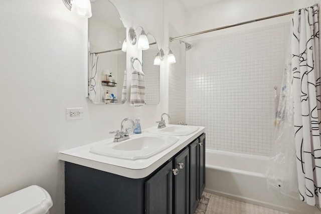 bathroom with double vanity, toilet, shower / bath combo with shower curtain, and a sink