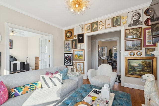 living room with ornamental molding, a chandelier, dark wood finished floors, and baseboards