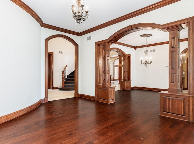 interior space featuring arched walkways, decorative columns, an inviting chandelier, dark wood-type flooring, and baseboards