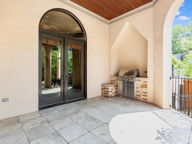 view of patio with an outdoor kitchen, area for grilling, and french doors