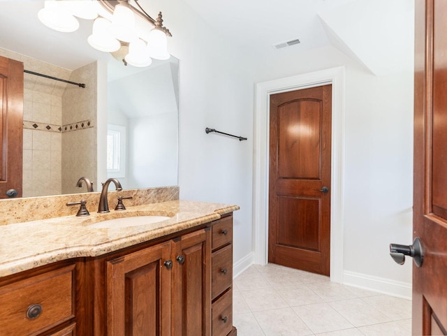 full bath featuring baseboards, visible vents, tile patterned floors, walk in shower, and vanity