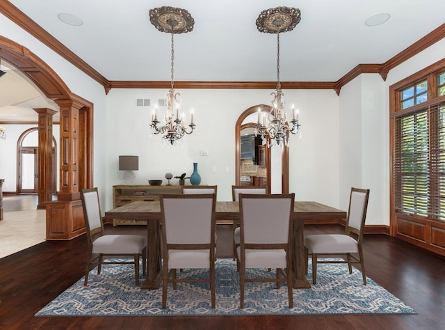 dining room with arched walkways, visible vents, ornamental molding, dark wood-style floors, and ornate columns